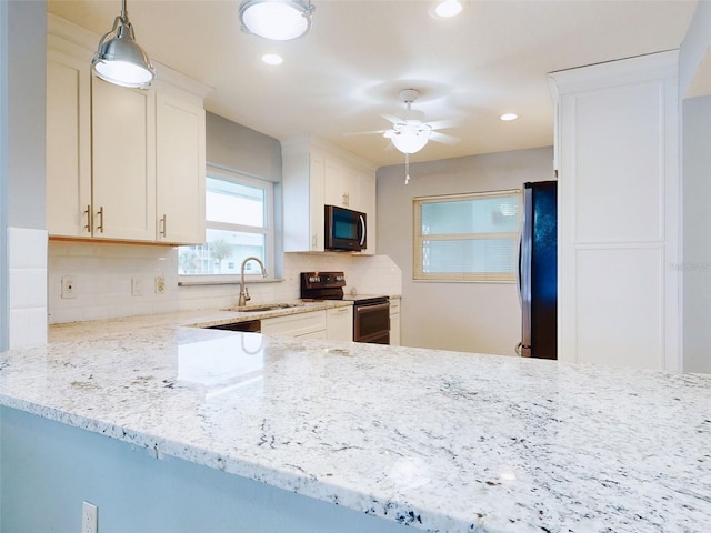 kitchen with white cabinetry, black range with electric stovetop, decorative backsplash, and stainless steel refrigerator