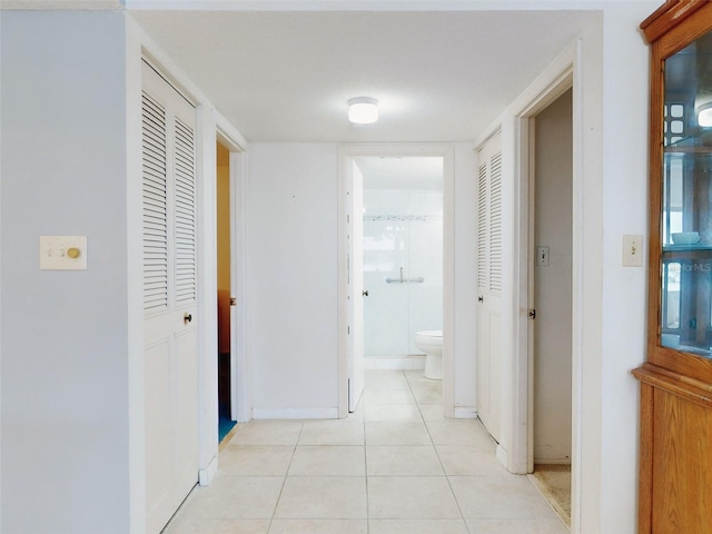 hall with light tile patterned floors