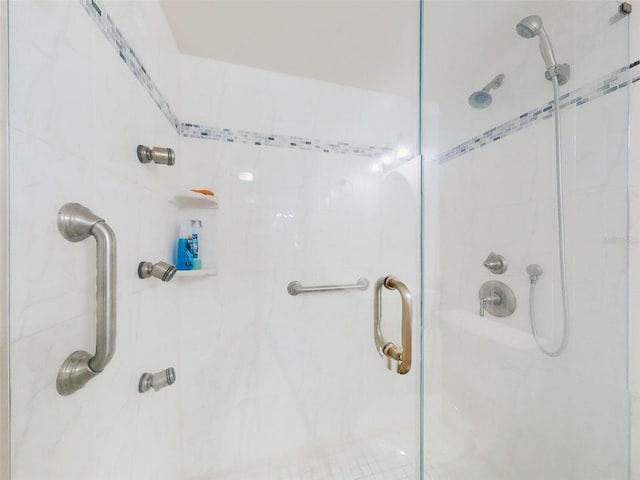 bathroom with a shower with shower door