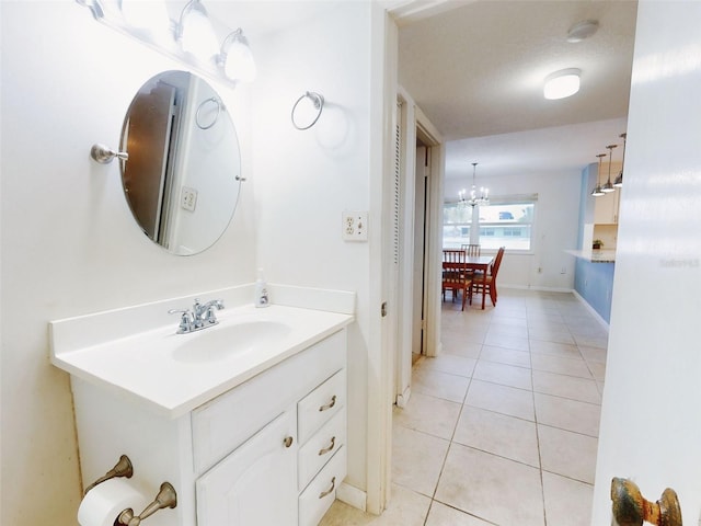 bathroom with vanity, tile patterned flooring, a textured ceiling, and a notable chandelier