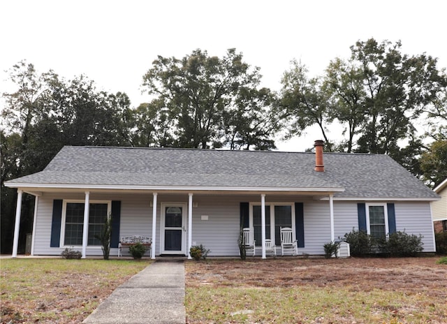 single story home with a front yard and a porch