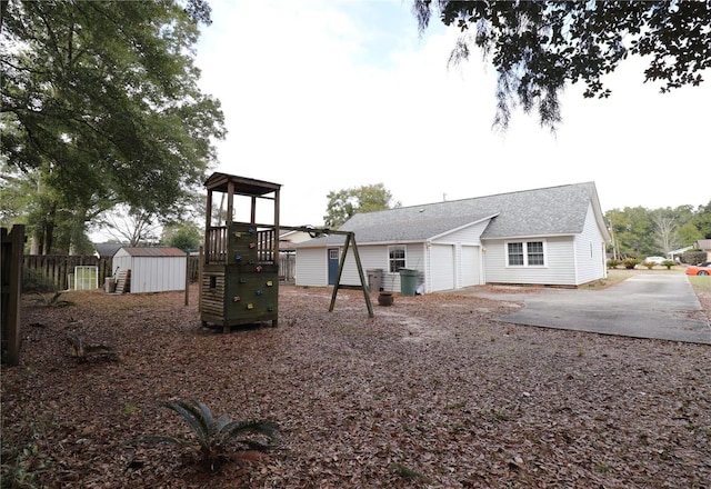 view of play area featuring a shed and a patio area