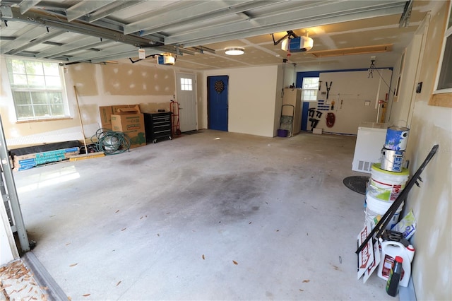 garage with a garage door opener and water heater