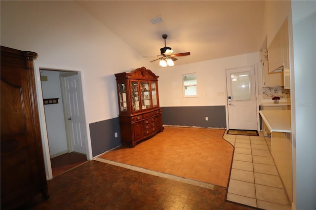 tiled entryway with high vaulted ceiling and ceiling fan