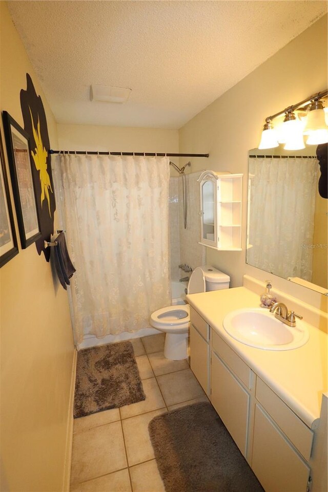 full bathroom with shower / tub combo with curtain, tile patterned flooring, vanity, a textured ceiling, and toilet