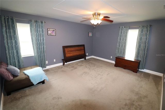 living area featuring ceiling fan, a healthy amount of sunlight, and carpet floors