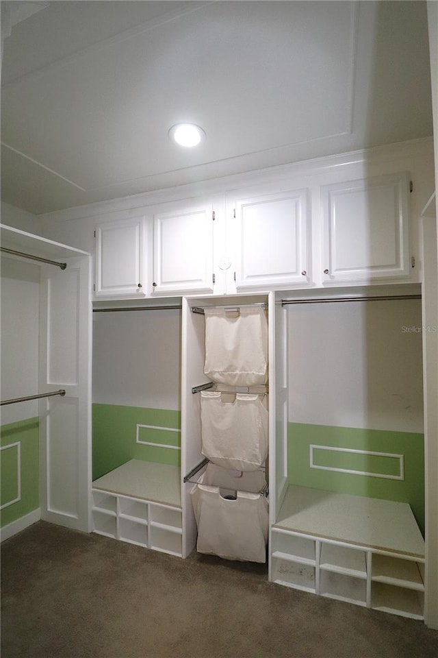 mudroom featuring dark colored carpet