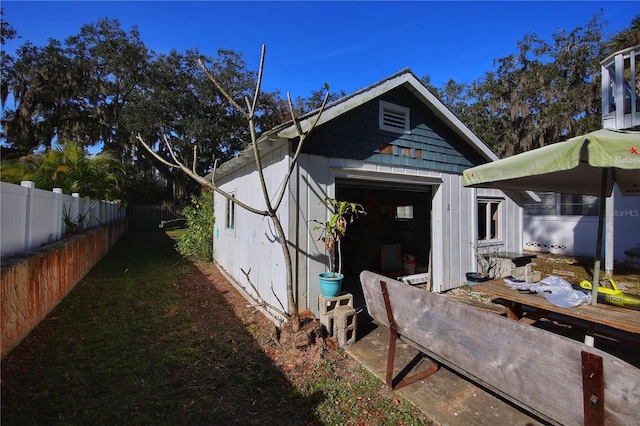 view of side of home featuring an outbuilding