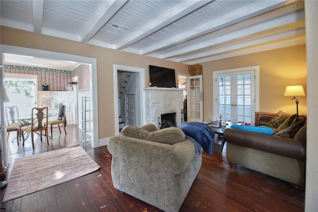 living room featuring dark wood-type flooring, beam ceiling, and french doors