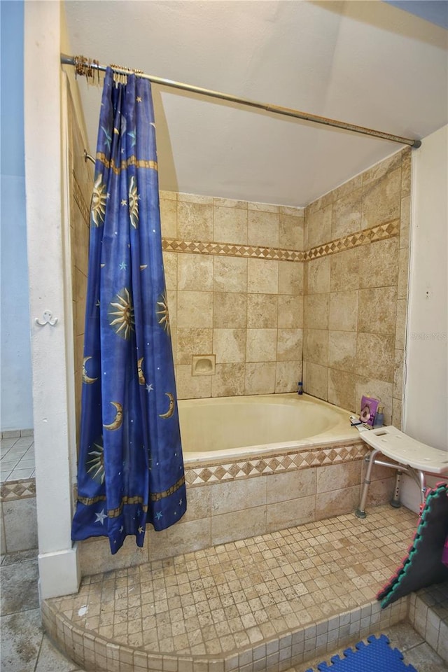 bathroom with shower / tub combo with curtain and tile patterned floors