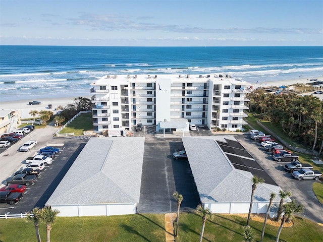 bird's eye view with a water view and a beach view