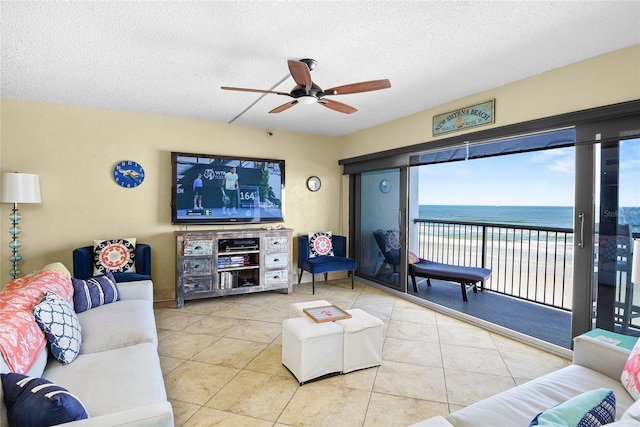 tiled living room featuring ceiling fan and a textured ceiling