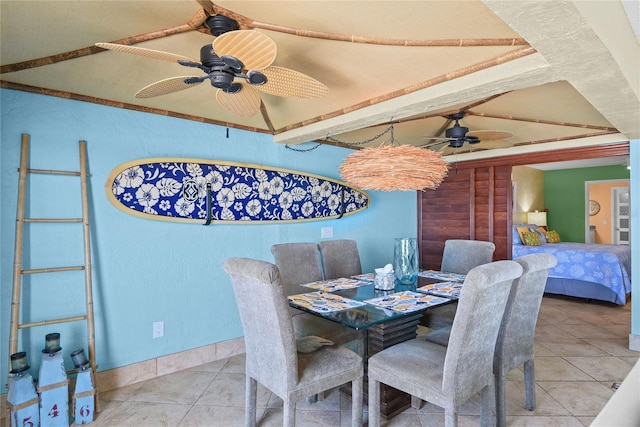 dining area featuring light tile patterned floors, lofted ceiling with beams, and ceiling fan