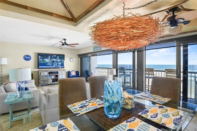 dining space featuring tile patterned flooring, ceiling fan, and a textured ceiling