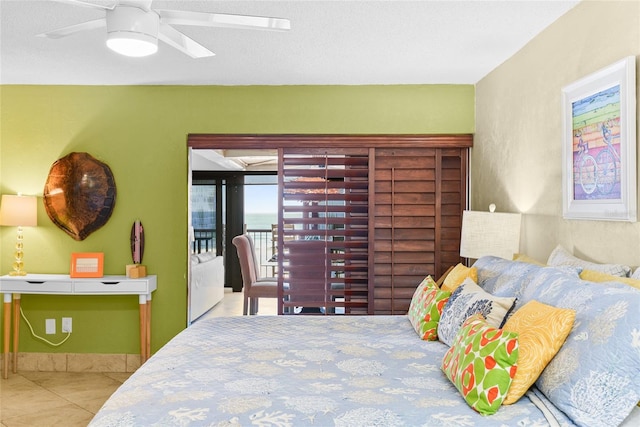 bedroom with access to outside, ceiling fan, and light tile patterned flooring