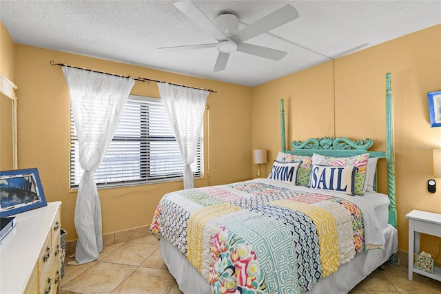 tiled bedroom with a textured ceiling and ceiling fan