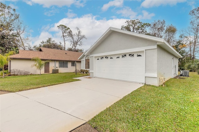 ranch-style home with a garage, a front lawn, and central air condition unit