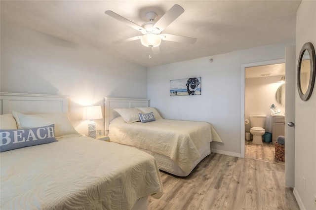 bedroom featuring ceiling fan, ensuite bath, and light hardwood / wood-style flooring