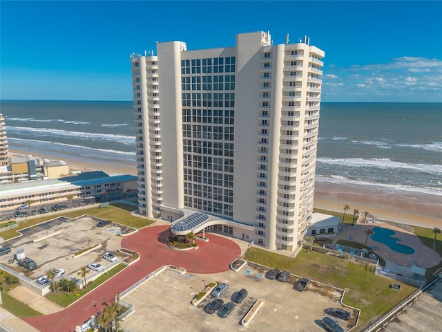 aerial view with a water view and a beach view