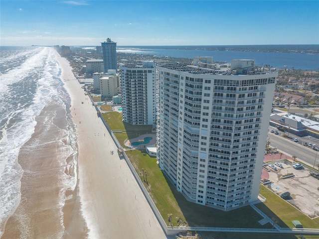 drone / aerial view featuring a water view and a beach view