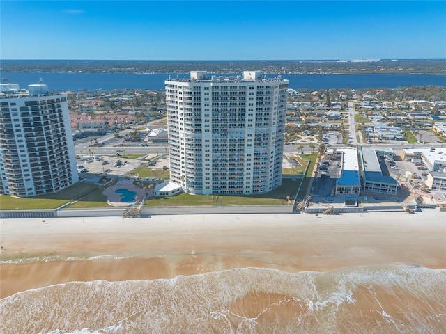 aerial view with a water view and a beach view