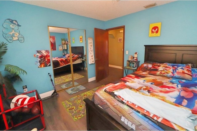 bedroom featuring dark hardwood / wood-style flooring and a closet