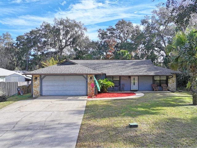 ranch-style house featuring a garage and a front yard