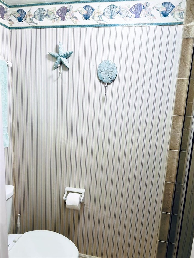 bathroom with a shower and toilet