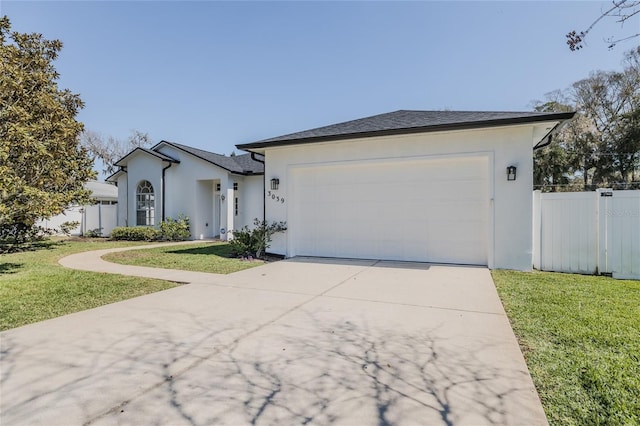 ranch-style home featuring a garage, concrete driveway, a front lawn, and fence