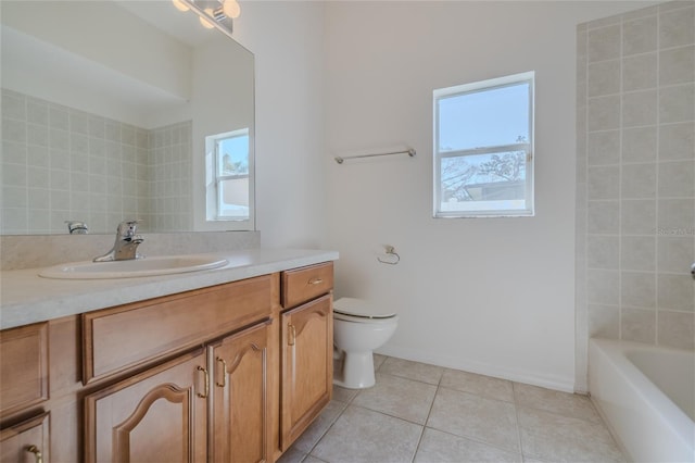 full bath with a healthy amount of sunlight, vanity, toilet, and tile patterned floors