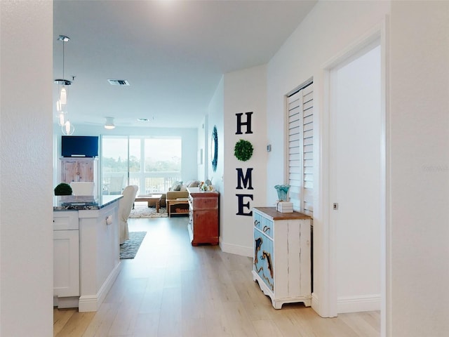 hallway with light hardwood / wood-style flooring