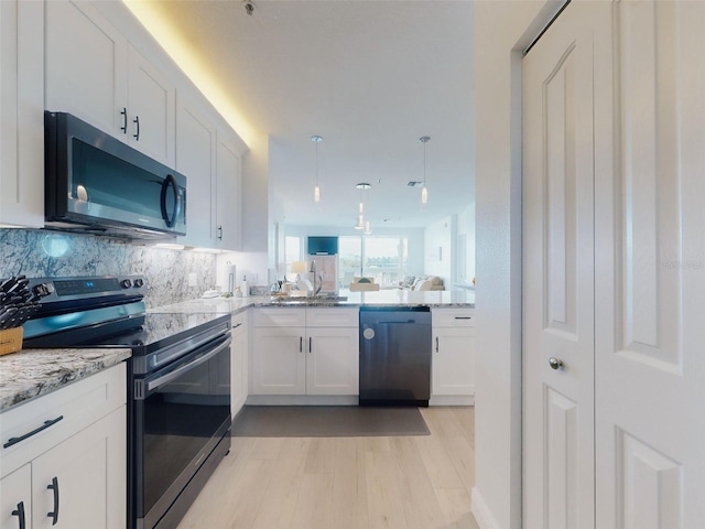 kitchen featuring sink, tasteful backsplash, dishwashing machine, electric stove, and white cabinets