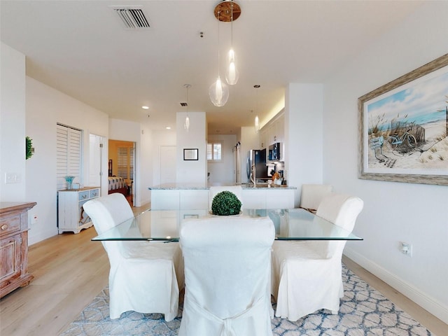 dining room with light hardwood / wood-style floors