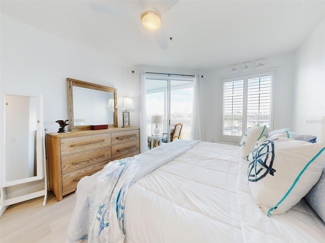 bedroom with access to outside and light hardwood / wood-style flooring