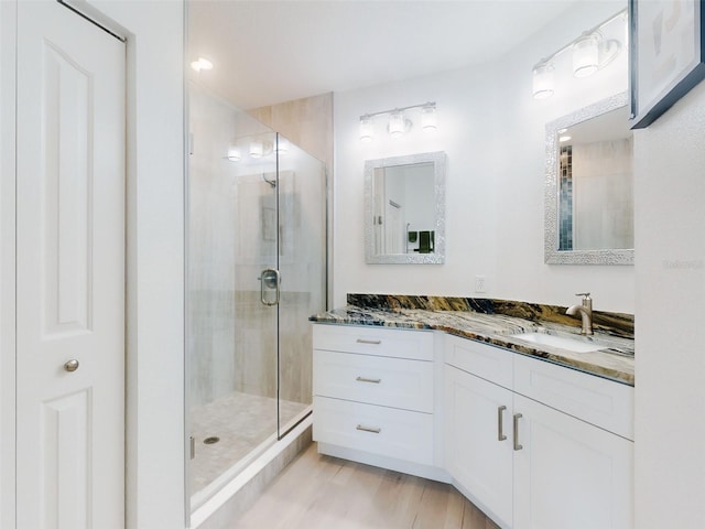 bathroom featuring vanity, a shower with door, and hardwood / wood-style floors