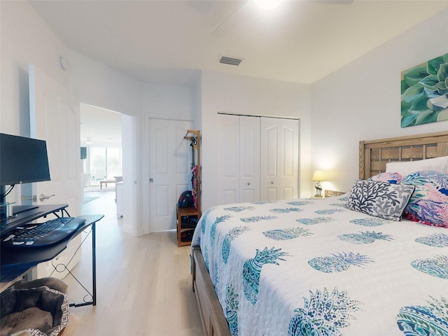 bedroom featuring light hardwood / wood-style flooring and a closet