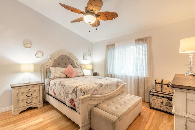 bedroom featuring light hardwood / wood-style flooring, ceiling fan, and vaulted ceiling