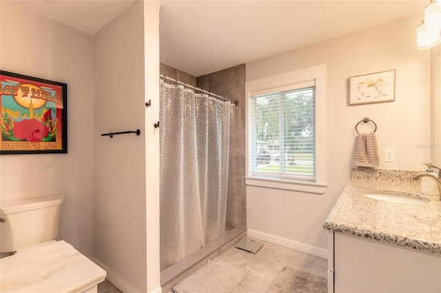 bathroom featuring vanity, toilet, and a shower with curtain