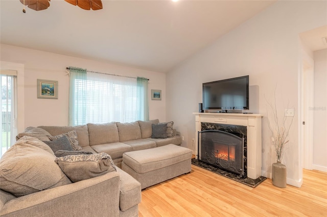 living room with lofted ceiling, plenty of natural light, and wood-type flooring