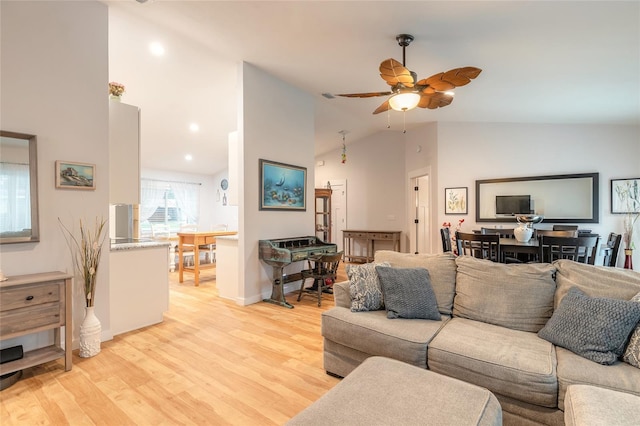 living room featuring ceiling fan, high vaulted ceiling, and light hardwood / wood-style floors