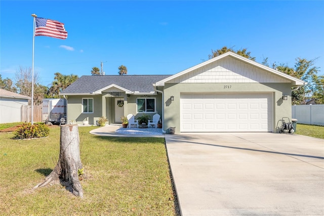 single story home featuring a garage and a front lawn