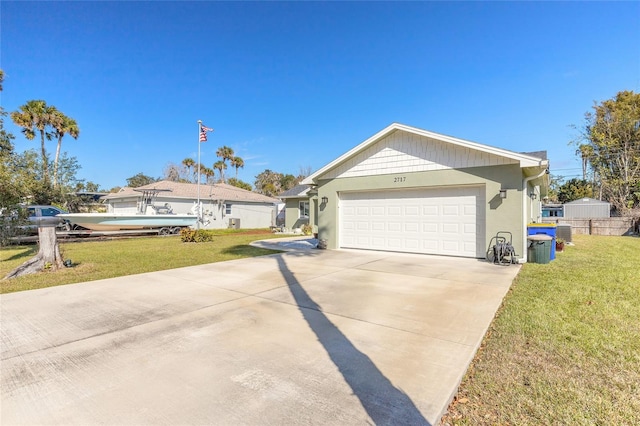 ranch-style house with a garage and a front lawn