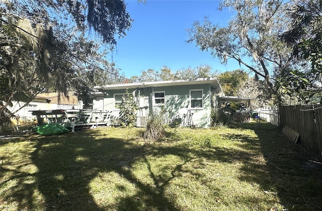 back of property featuring a lawn