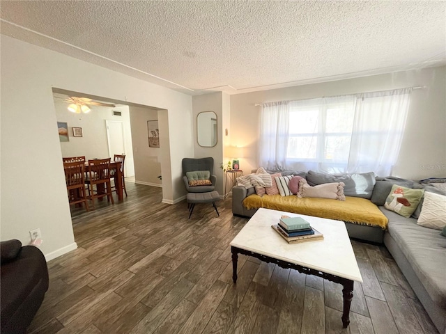 living room with a textured ceiling and dark hardwood / wood-style flooring