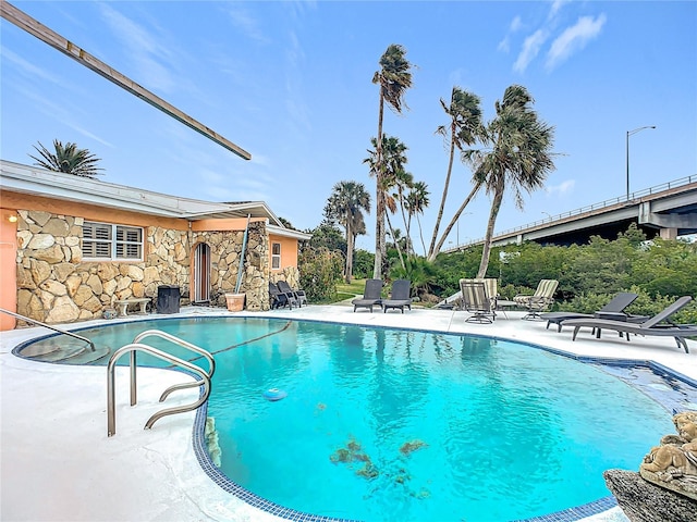 view of swimming pool featuring a patio area