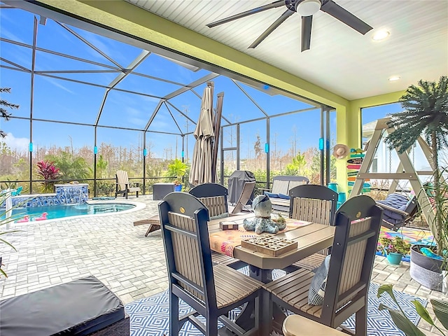 view of patio featuring a lanai, pool water feature, and ceiling fan