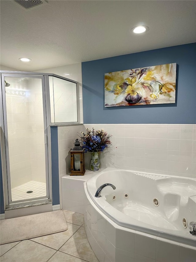 bathroom featuring tile patterned floors and independent shower and bath