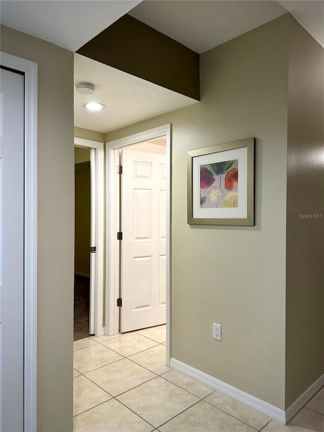 corridor with light tile patterned flooring