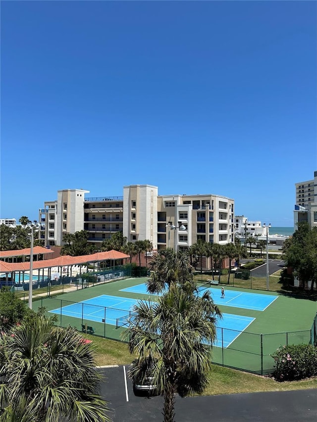 view of sport court with a water view