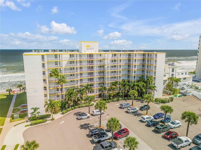 view of property featuring a view of the beach and a water view